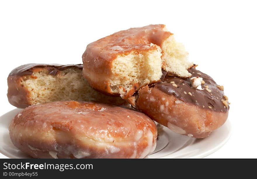 A plate of doughnuts over a white background