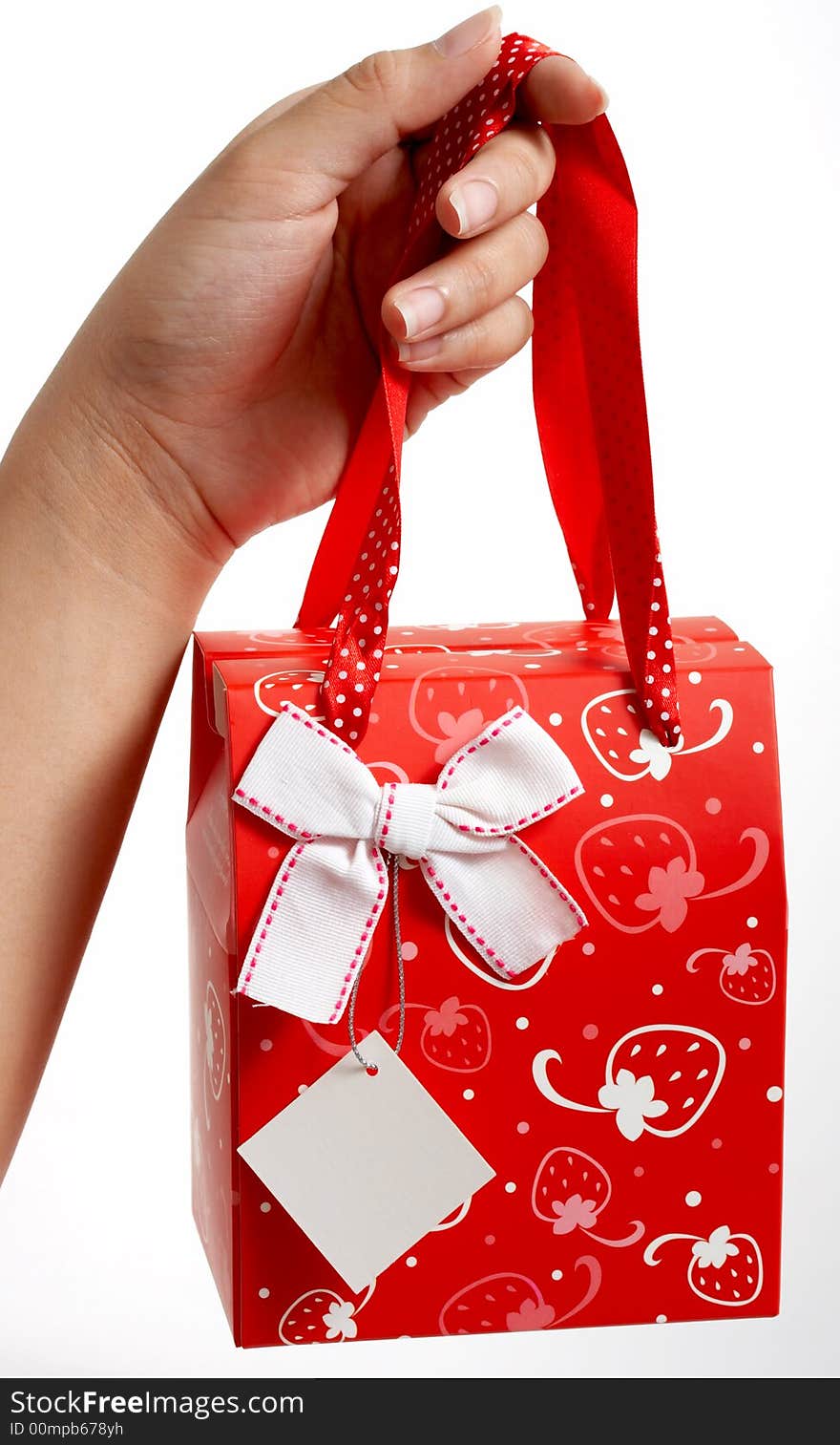 A hand holding a gift bag