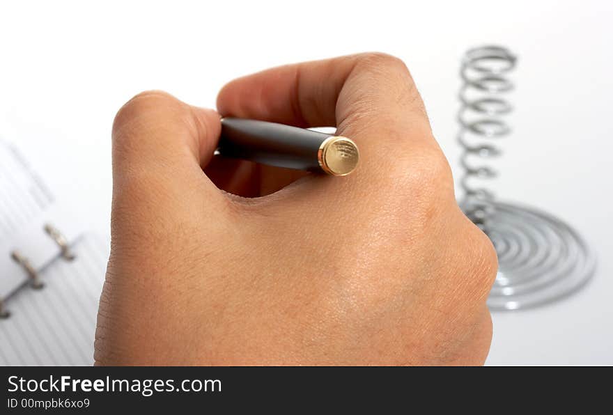 A pen and an organizer over a white background. A pen and an organizer over a white background