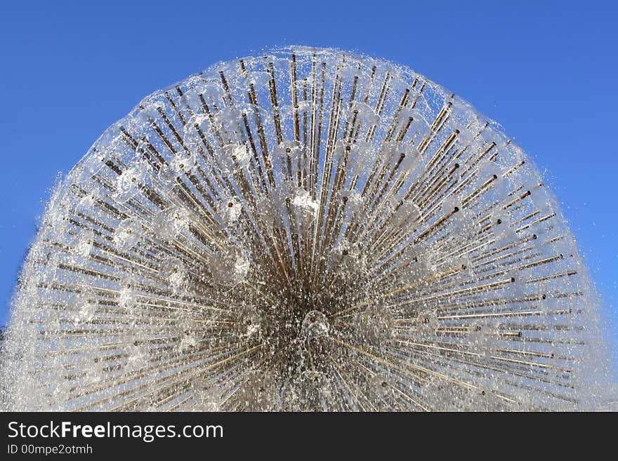 Water fountain on a background of the dark blue sky