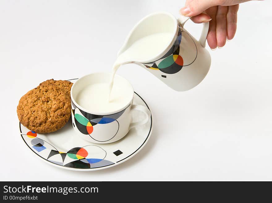 Woman, pouring milk to cup on white