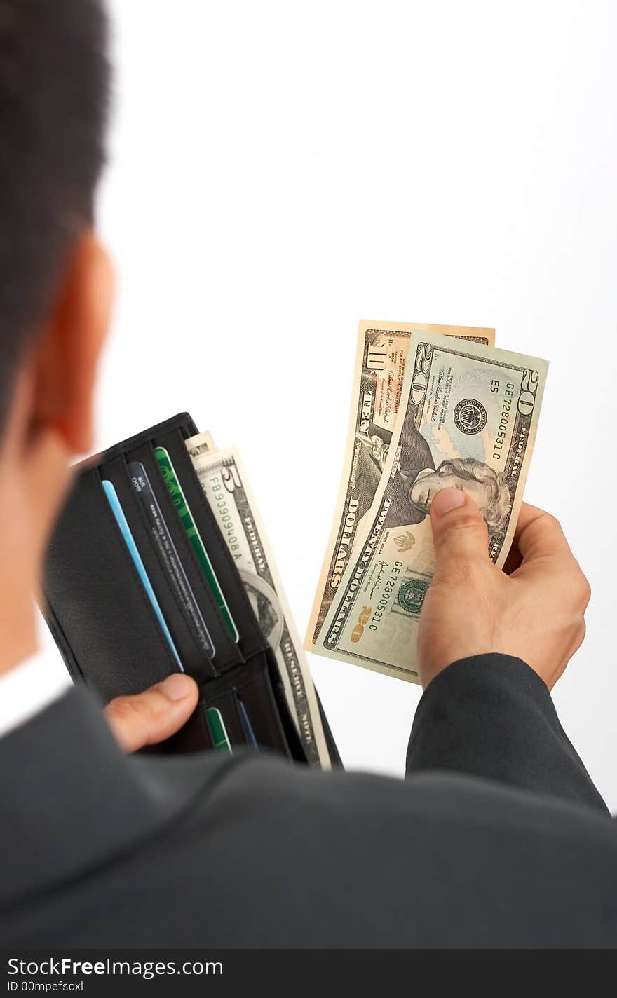 A businessman holding a wallet with dollar bills