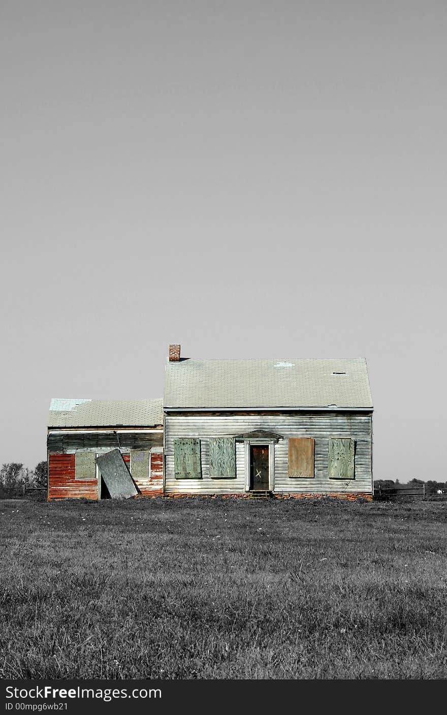 An Old abandoned house with grass and sky