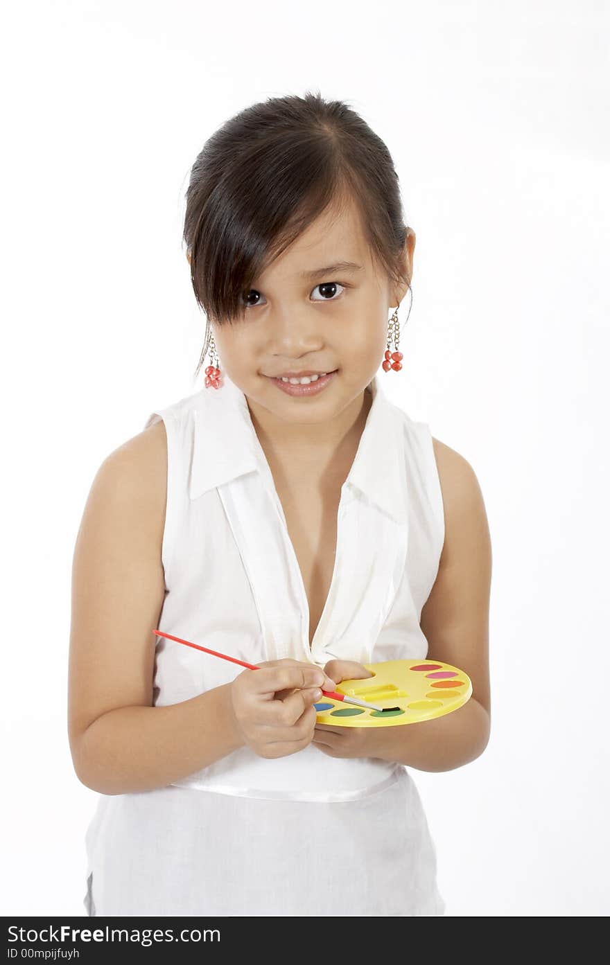 A girl holding a paint brush and a pallete. A girl holding a paint brush and a pallete