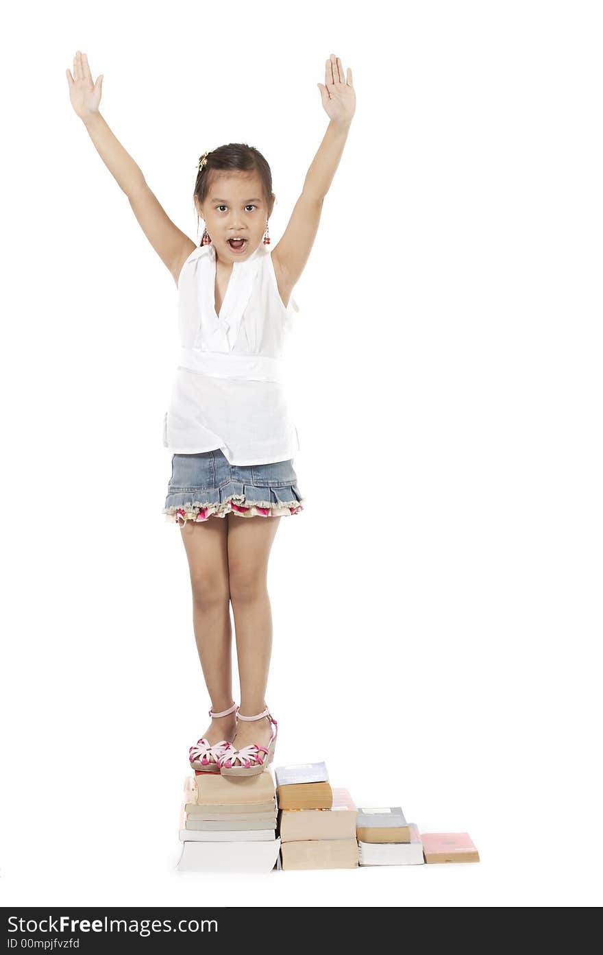 A girl climbing up by stepping on book stacks. A girl climbing up by stepping on book stacks