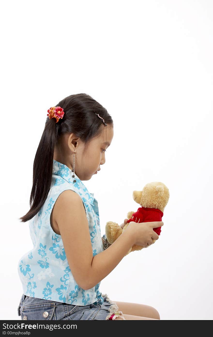 A girl with a teddy bear over a white background