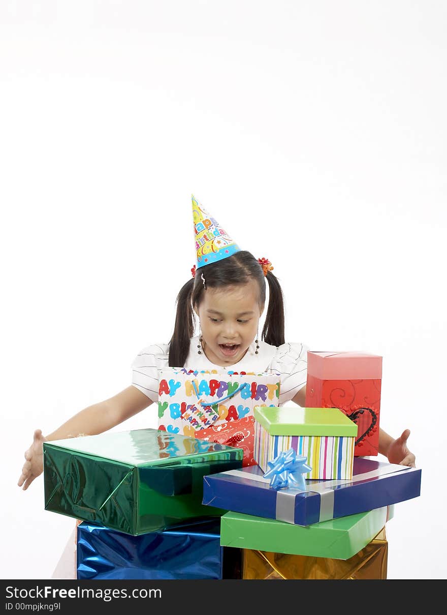 A girl wearing a party hat over a white background. A girl wearing a party hat over a white background