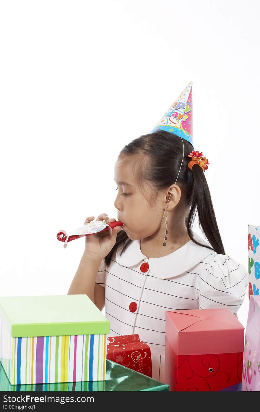 A girl wearing a party hat over a white background. A girl wearing a party hat over a white background