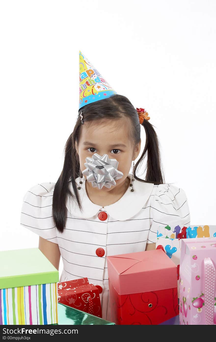 A girl wearing a party hat over a white background. A girl wearing a party hat over a white background