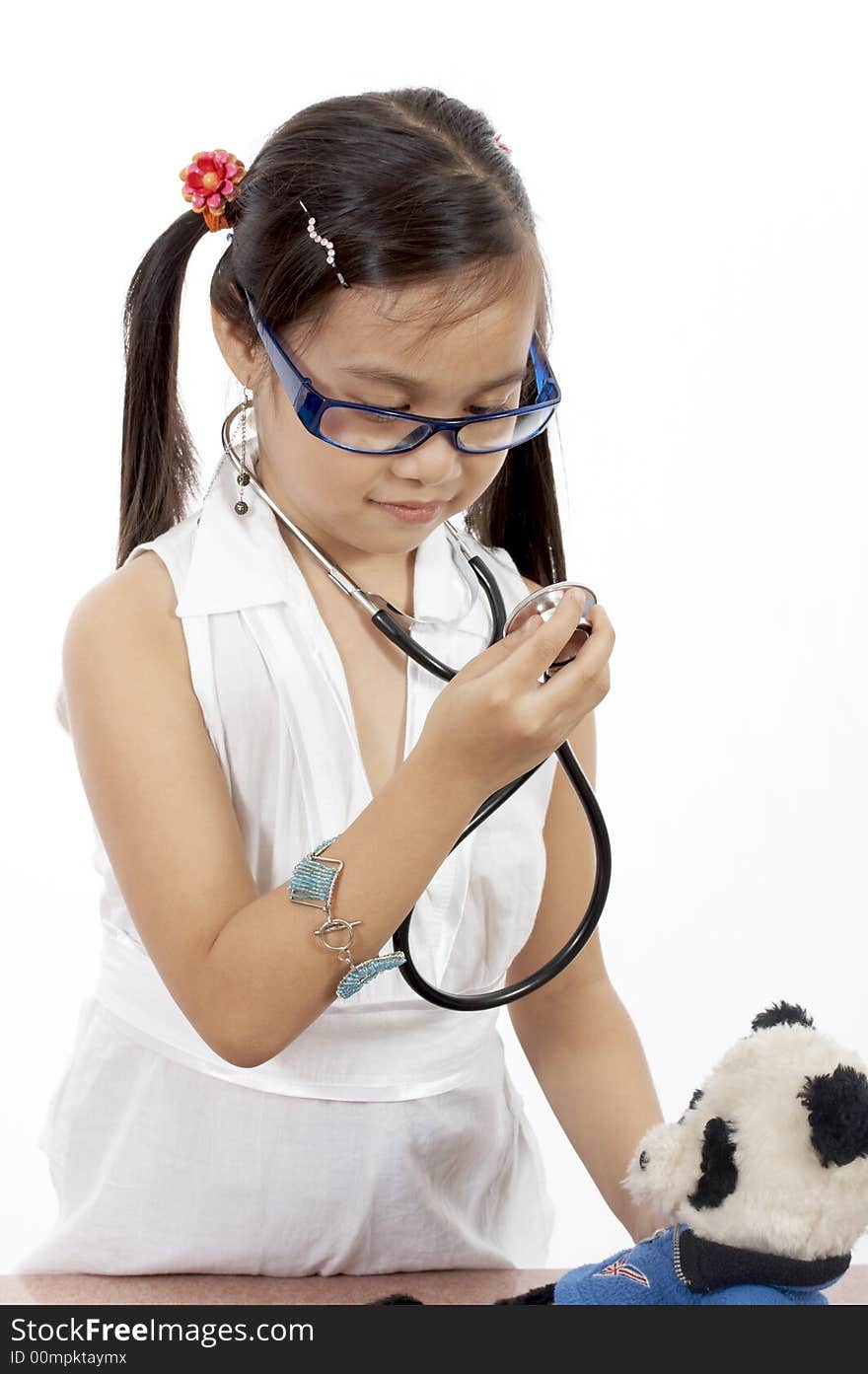 A girl playing doctor over a white background