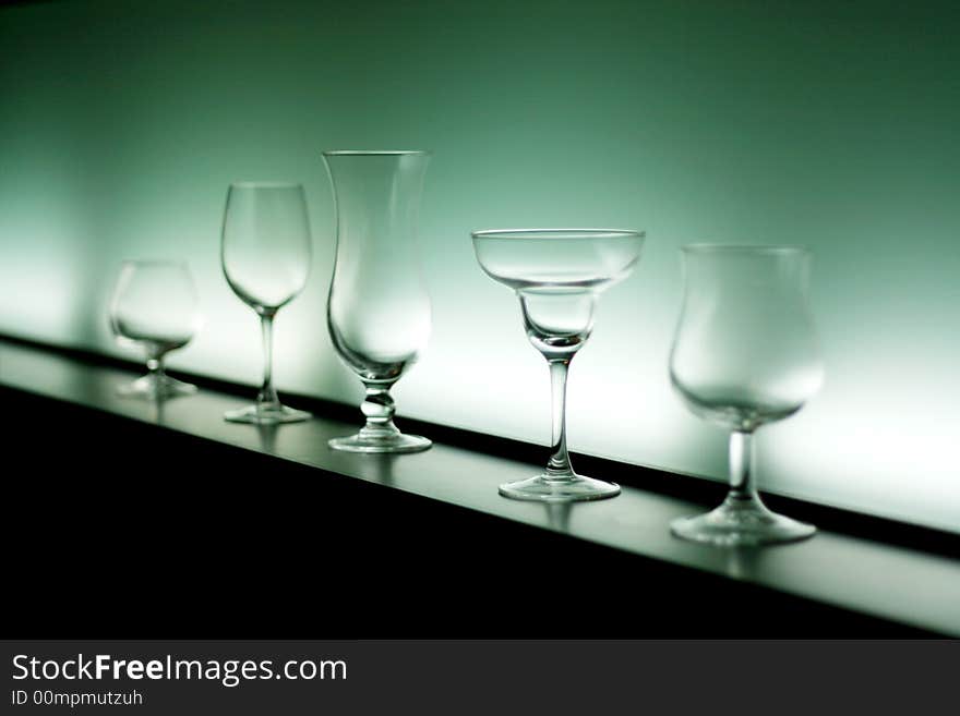 Five shapes of empty cocktails glass, selective focus on fourth glass. Five shapes of empty cocktails glass, selective focus on fourth glass