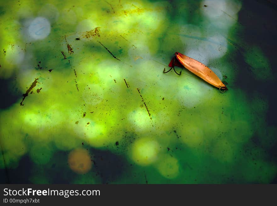 Antique copper fishing lure on beautiful grunge background. Antique copper fishing lure on beautiful grunge background