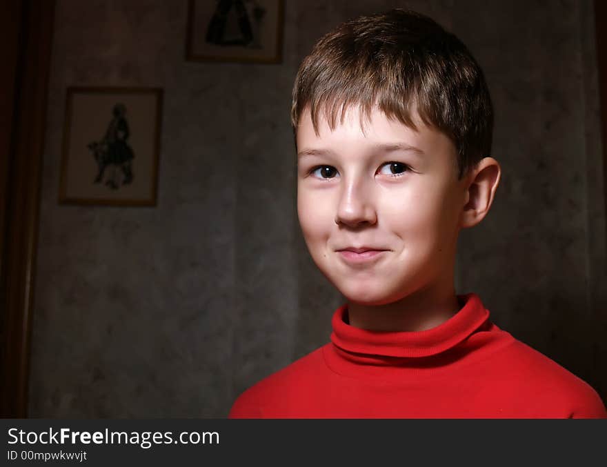 Smiling little boy in dark room. Smiling little boy in dark room