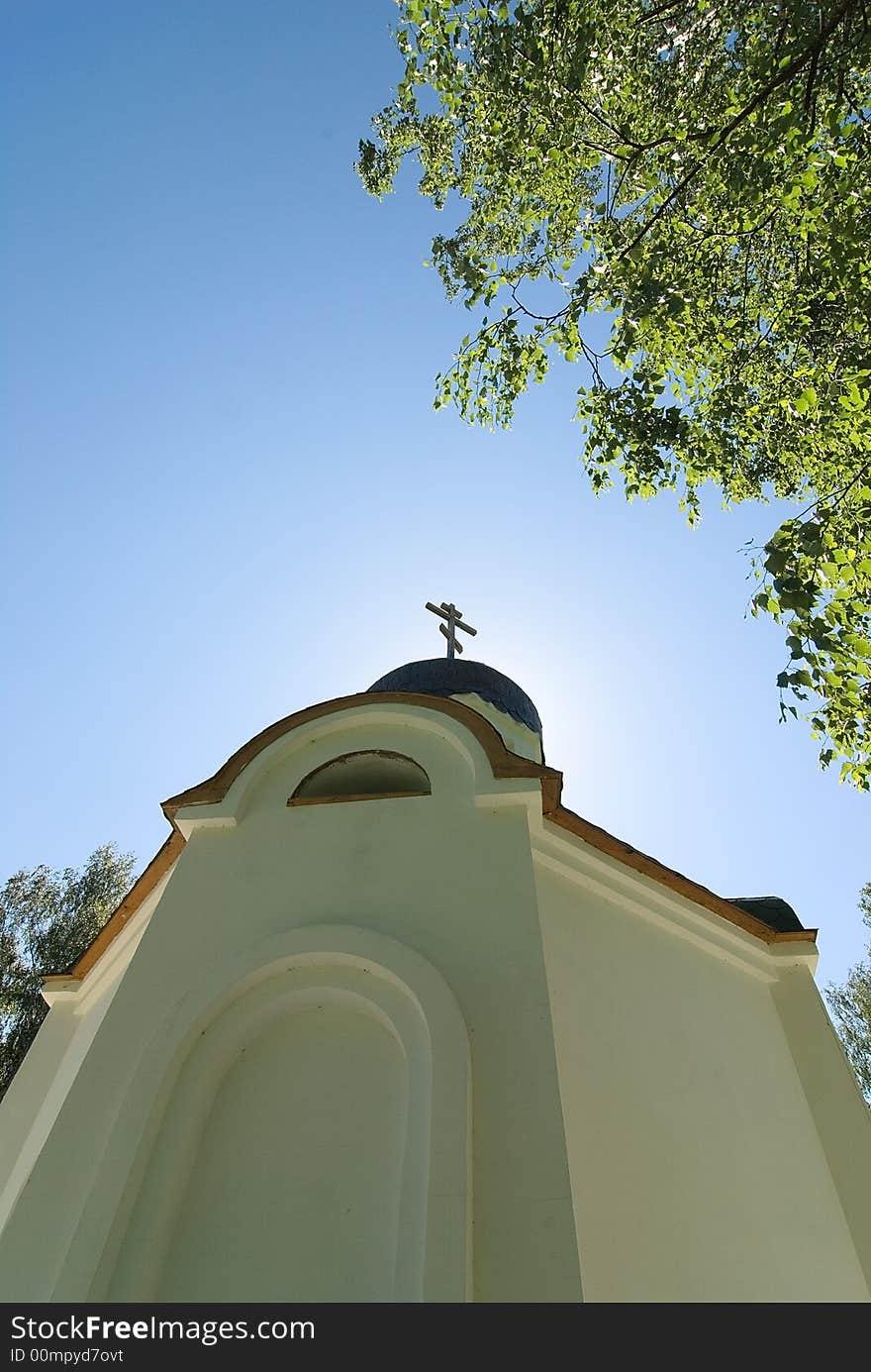 Church in the wood, cross and clear blue sky