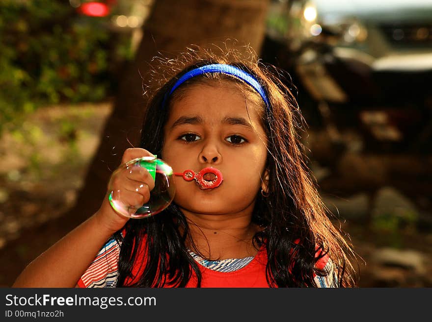 A girl releasing the bubble.