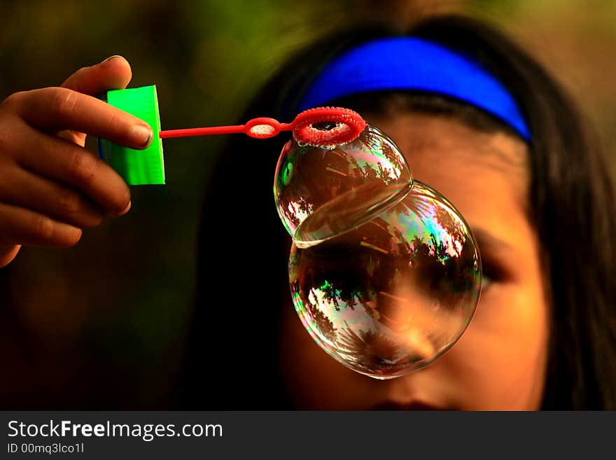 A close up  of a hand holding twin bubbles. A close up  of a hand holding twin bubbles.