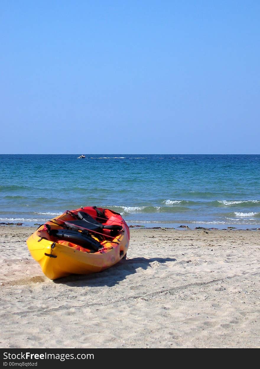 Yellow and red kayak on the beach