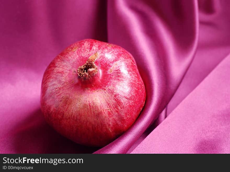 Piece of pomegranate on pink background