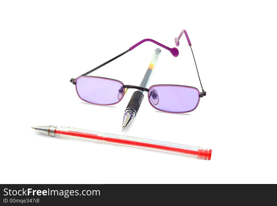 Isolated red and black pens and lilac glasses. Isolated red and black pens and lilac glasses