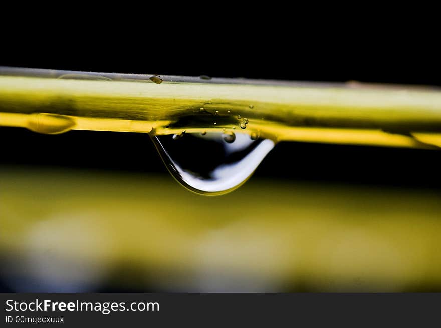 Photo of a water droplet suspended from a plastic line. Photo of a water droplet suspended from a plastic line