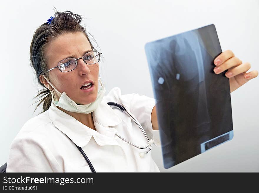 Young female doctor looking radiogram