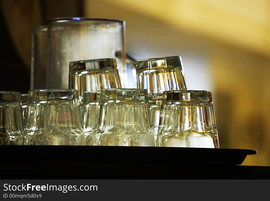 Clean glass on tray waiting in a cafe or bar. Clean glass on tray waiting in a cafe or bar