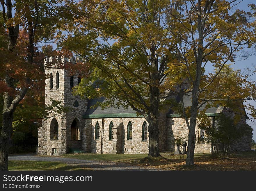 Stone Church with lined and framed trees around