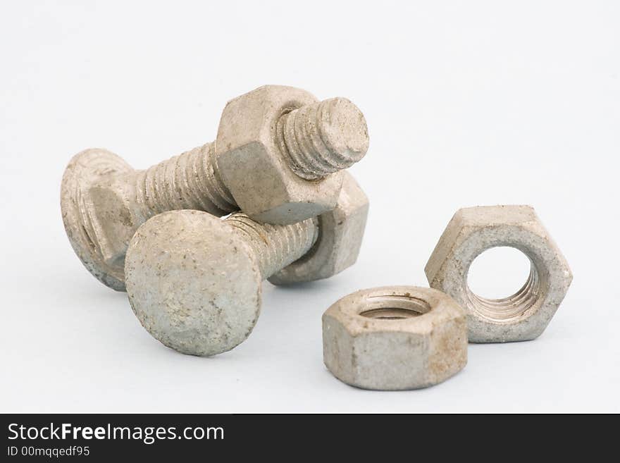 A closeup of two large bolts and nuts. A closeup of two large bolts and nuts.