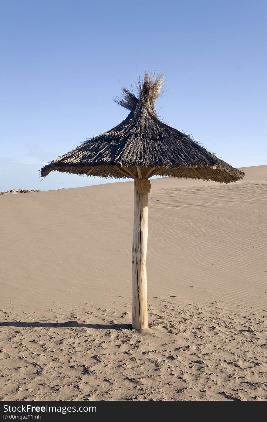 Parasol on a sandy beach. Parasol on a sandy beach