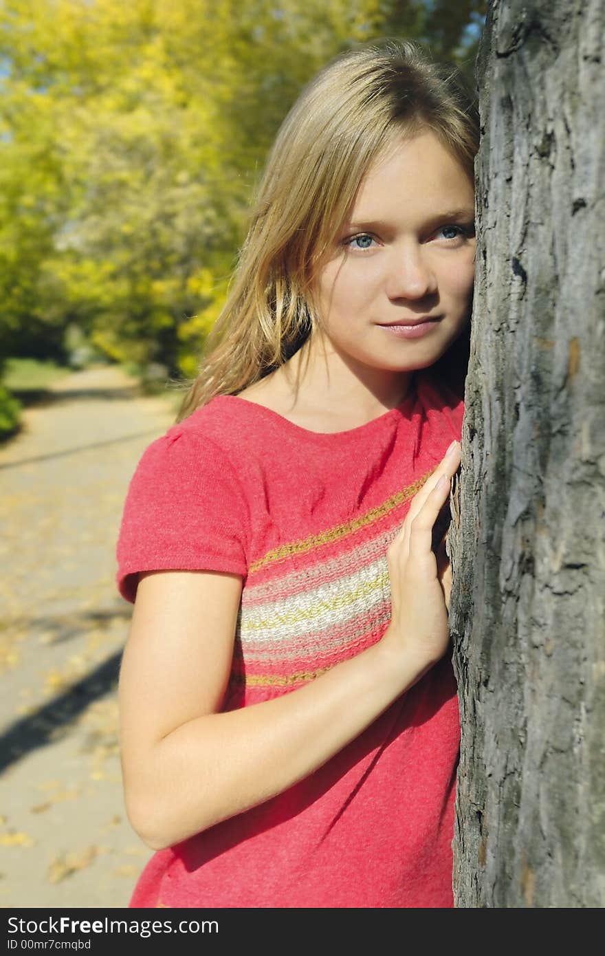 Blond girl in the autumn park