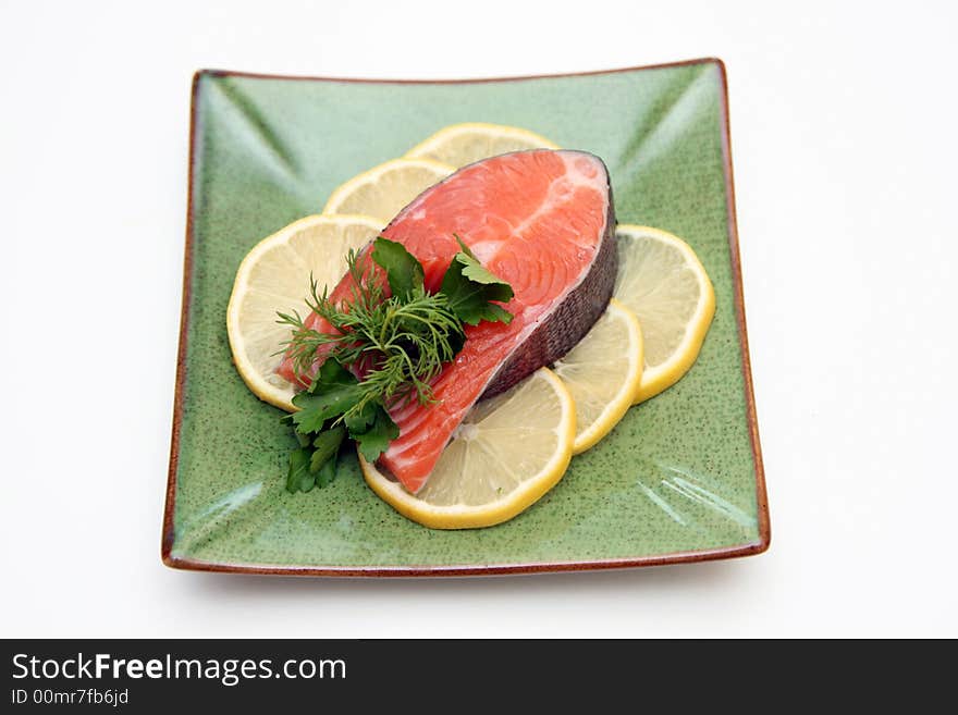 Salmon with lemon and parsley on plate