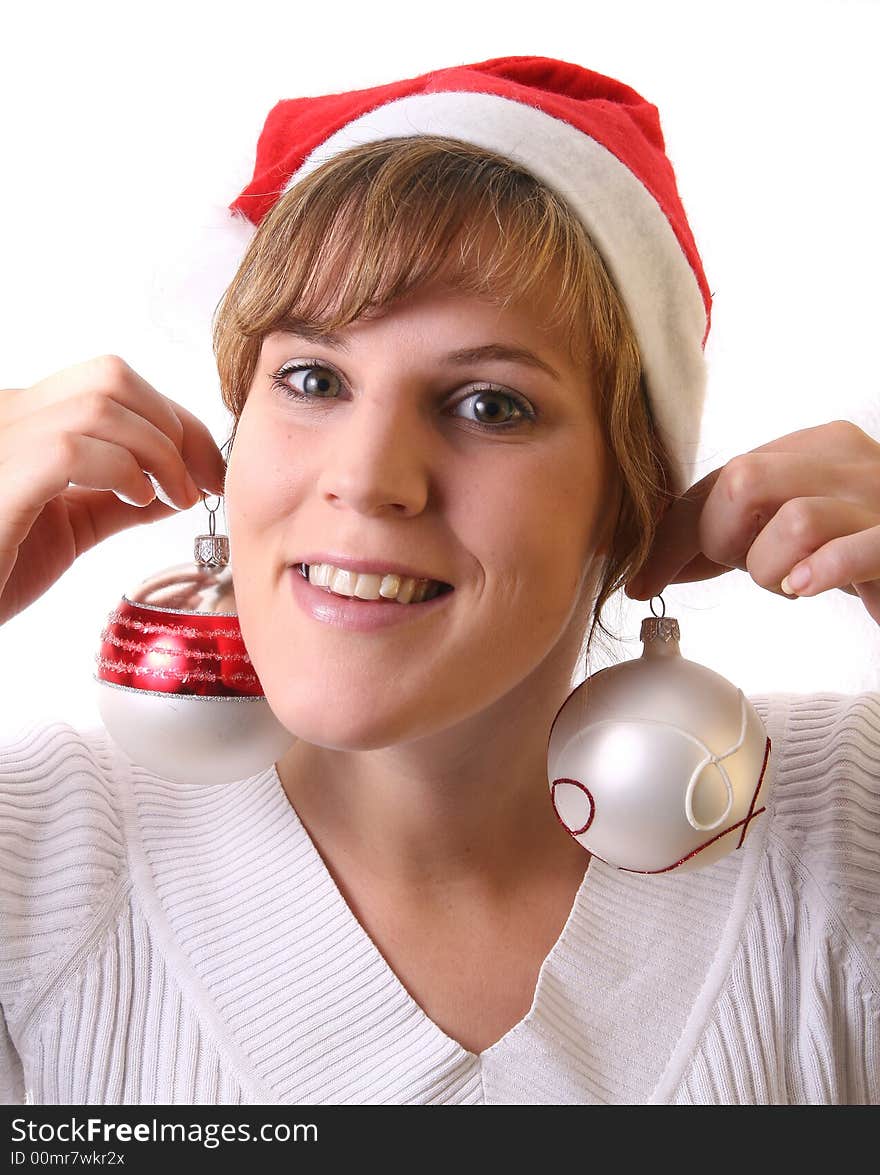 A young beautiful cute and happy Christmas woman is smiling. Isolated over white with a Christmas glitter balls. A young beautiful cute and happy Christmas woman is smiling. Isolated over white with a Christmas glitter balls.