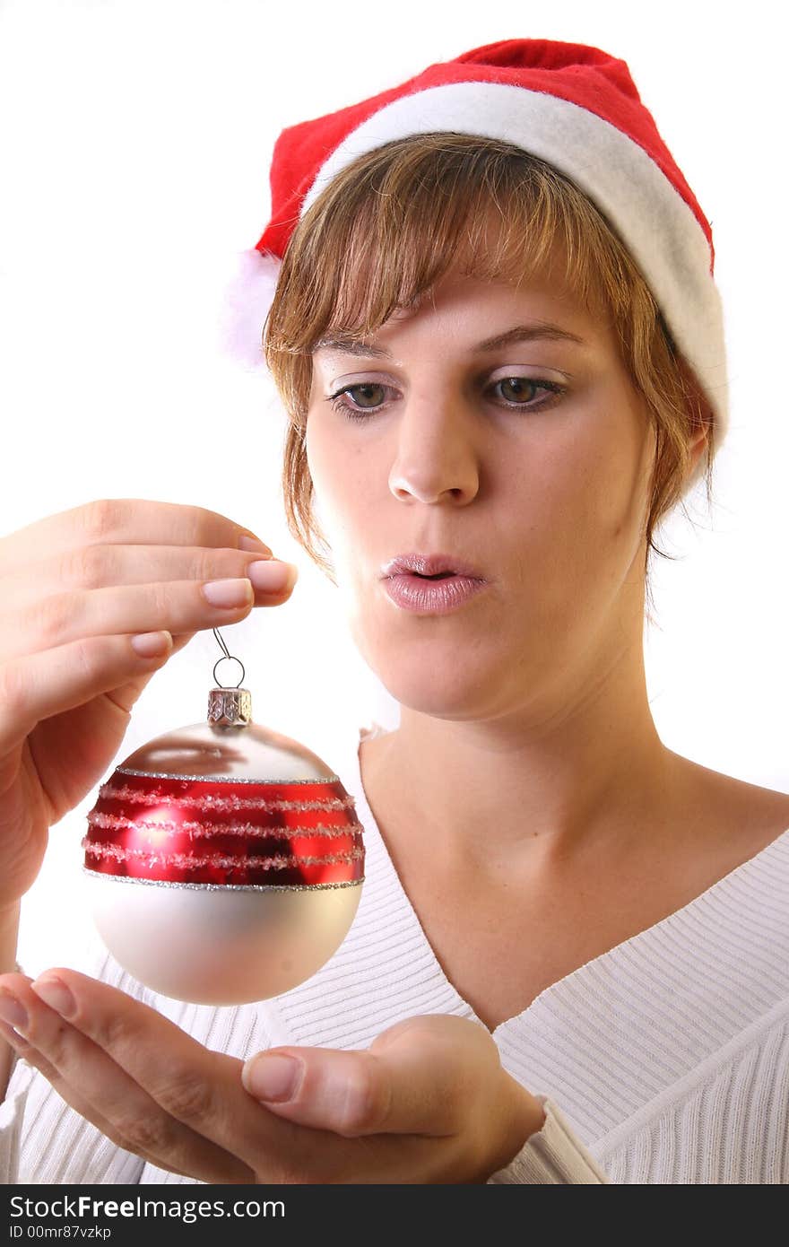 A young beautiful cute and happy Christmas woman is smiling. Isolated over white with a Christmas glitter ball. A young beautiful cute and happy Christmas woman is smiling. Isolated over white with a Christmas glitter ball.