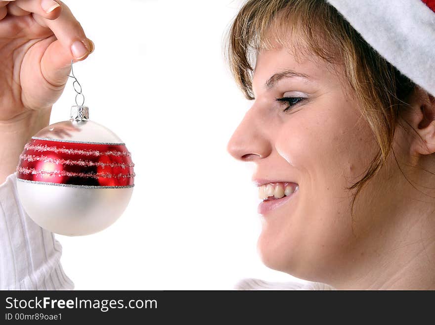 A young beautiful cute and happy Christmas woman is smiling. Isolated over white with a Christmas glitter ball. A young beautiful cute and happy Christmas woman is smiling. Isolated over white with a Christmas glitter ball.