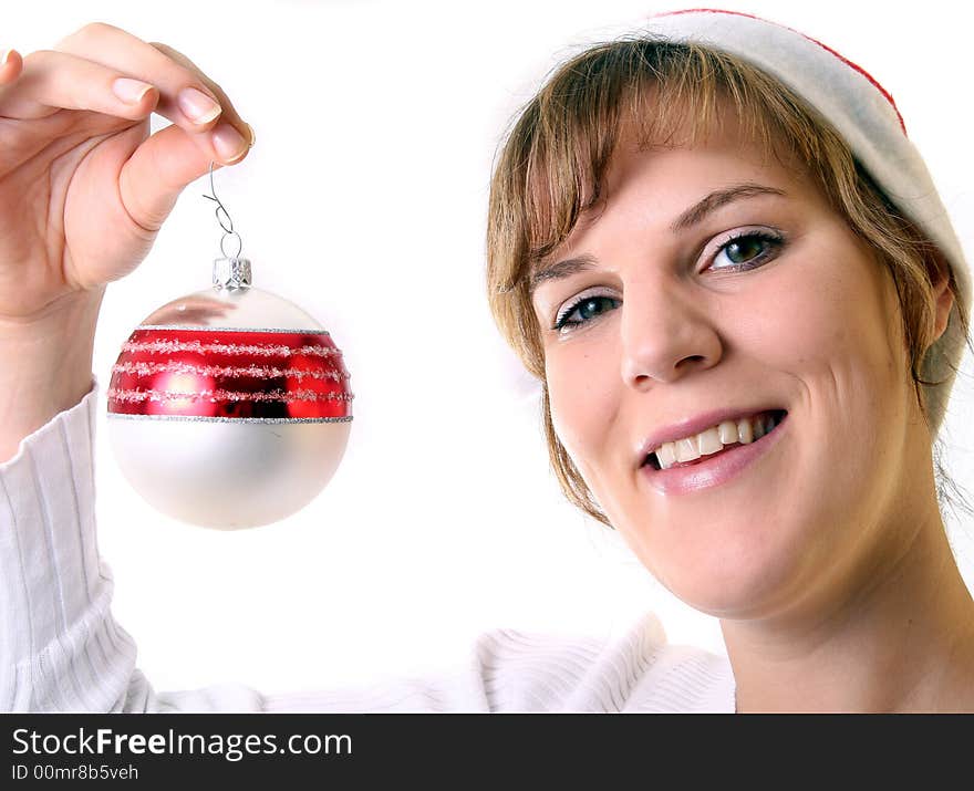 A young beautiful cute and happy Christmas woman is smiling. Isolated over white with a Christmas glitter ball. A young beautiful cute and happy Christmas woman is smiling. Isolated over white with a Christmas glitter ball.