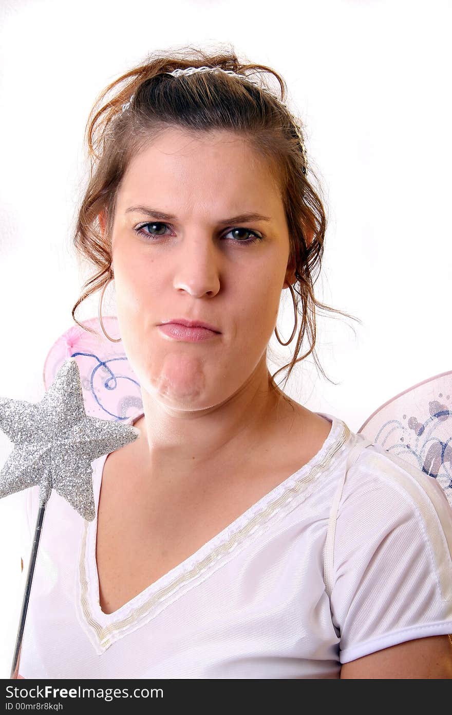 A young beautiful cute and frumpy Christmas fairy with wings and a magic wand getting ready for Christmas! Isolated over white!. A young beautiful cute and frumpy Christmas fairy with wings and a magic wand getting ready for Christmas! Isolated over white!