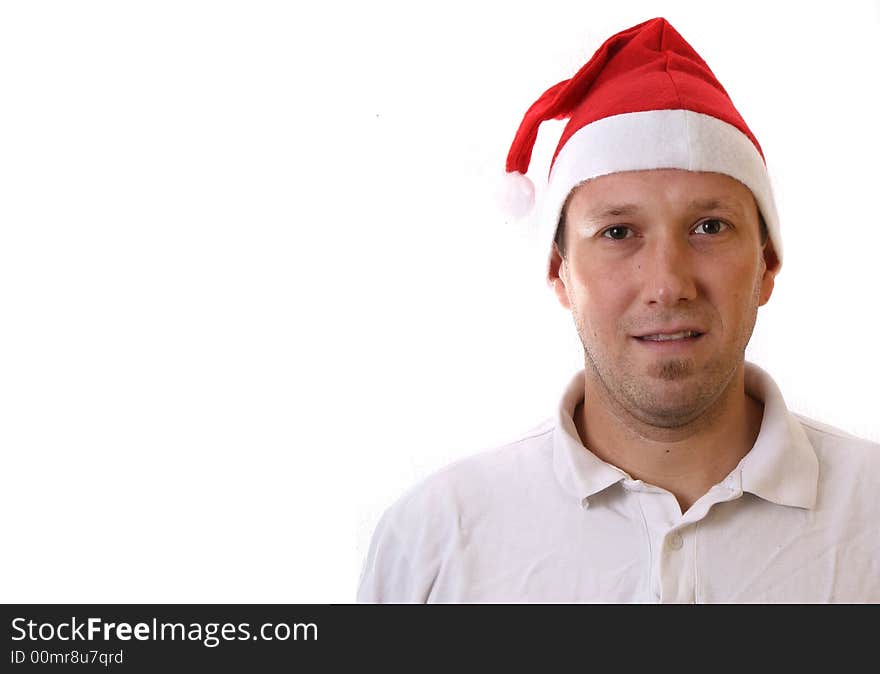 A young man with a santa claus hat is smiling. Isolated over white! Lots of copyspace to write text in!. A young man with a santa claus hat is smiling. Isolated over white! Lots of copyspace to write text in!