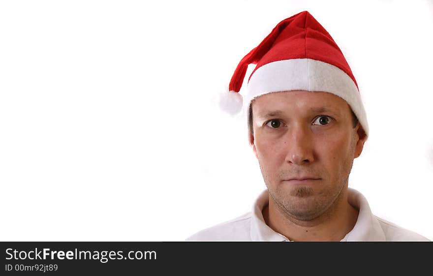 A young man with a santa claus hat. Isolated over white! Lots of copyspace to write text in!. A young man with a santa claus hat. Isolated over white! Lots of copyspace to write text in!