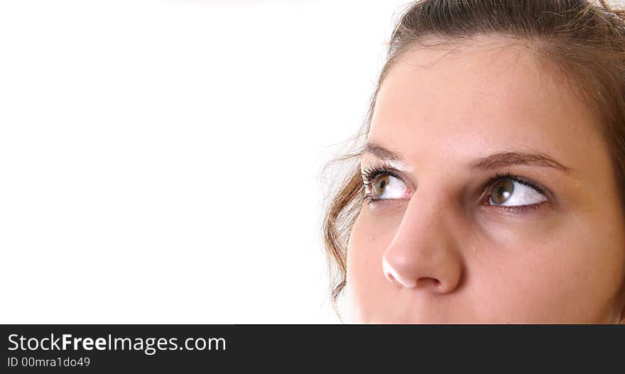 A young woman is looking up into the corner over white background. Ideal for business and corporate purposes. Lots of white copyspace and room for text on this isolated area.