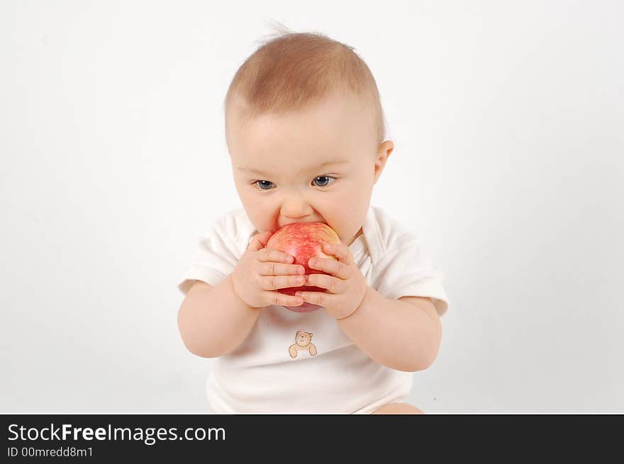 Sweet baby eating apple on white background. Sweet baby eating apple on white background