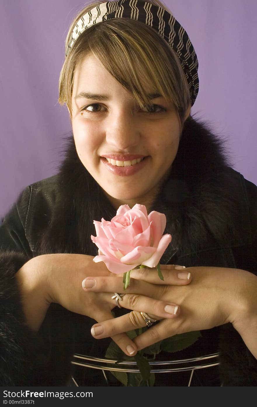 Portrait of a young attractive woman with rose