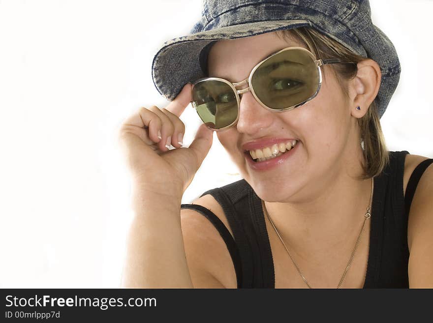 Portrait of a young attractive woman with glasses and cap