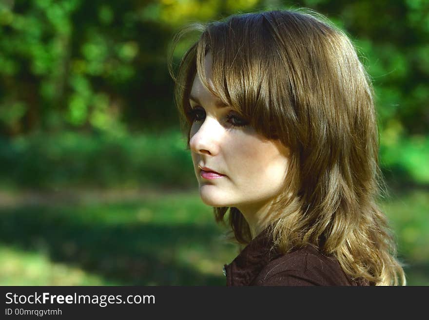 Girl walking and dreaming in the park in a sunny day. Girl walking and dreaming in the park in a sunny day