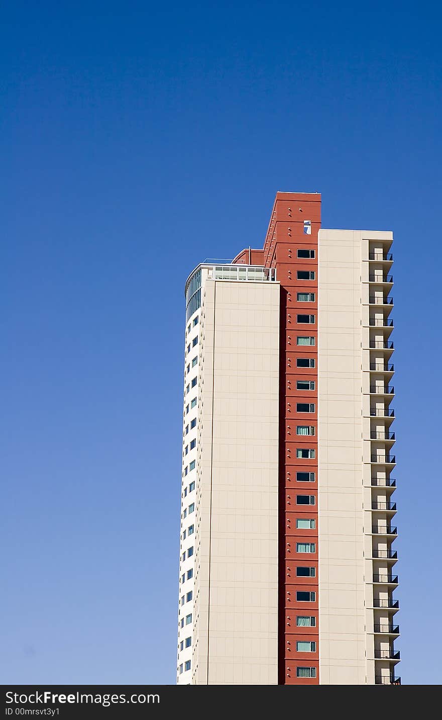 A high rise condo tower against blue sky. A high rise condo tower against blue sky