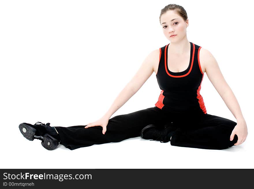 A young caucasian girl doing different stretches. A young caucasian girl doing different stretches