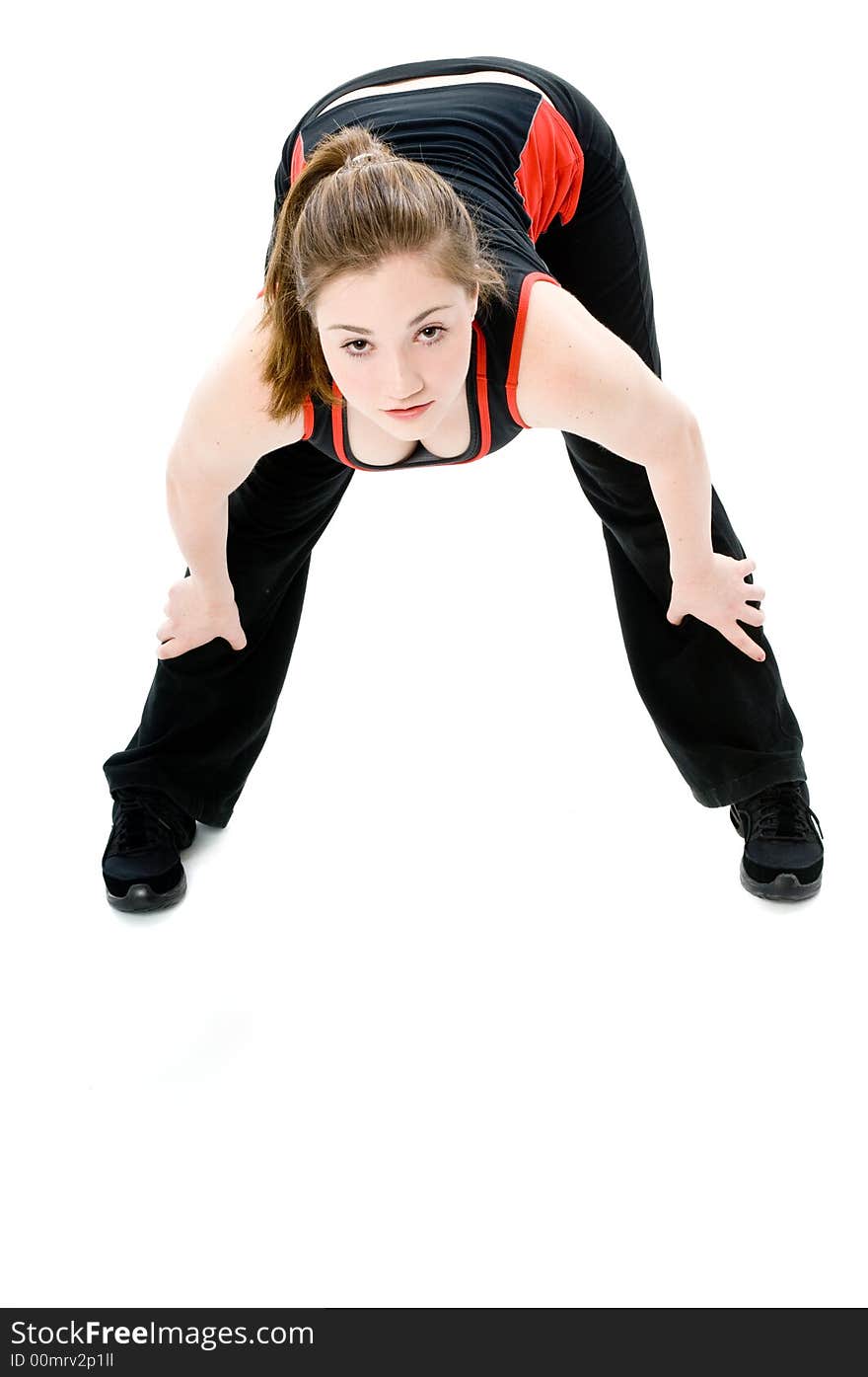 A young caucasian girl doing different stretches. A young caucasian girl doing different stretches