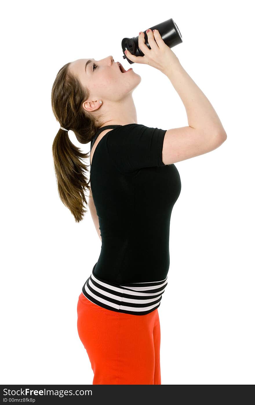 Young caucasian girl drinking from an exercise bottle. Young caucasian girl drinking from an exercise bottle