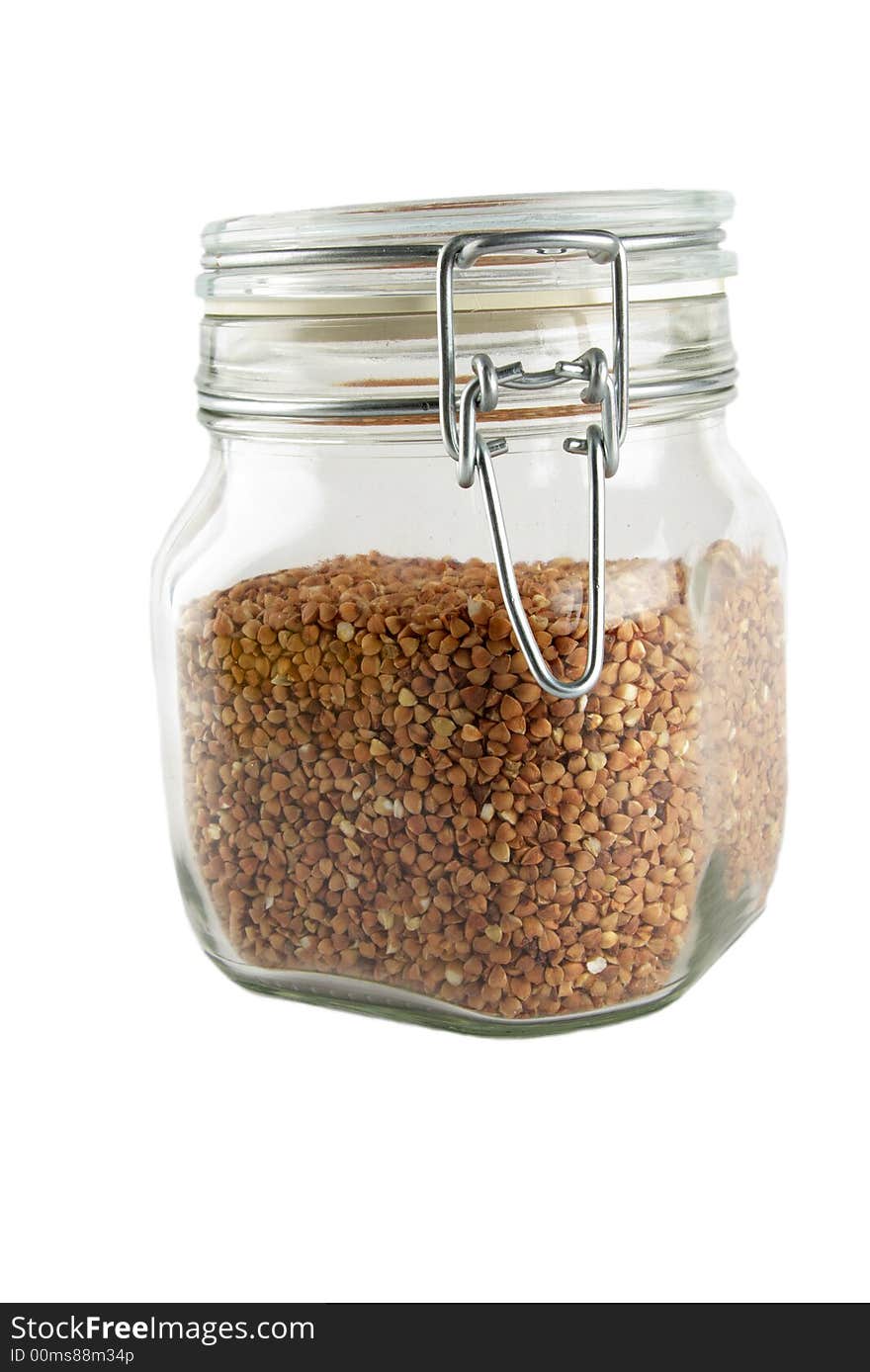 Glass container with buckwheat isolated on white. Glass container with buckwheat isolated on white