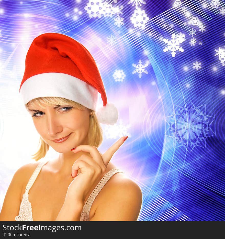 Beautiful girl in Christmas hat on abstract winter background