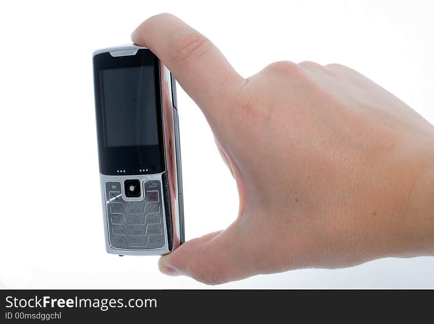 Small Silver Mobile Phone Device in hand. Small Silver Mobile Phone Device in hand